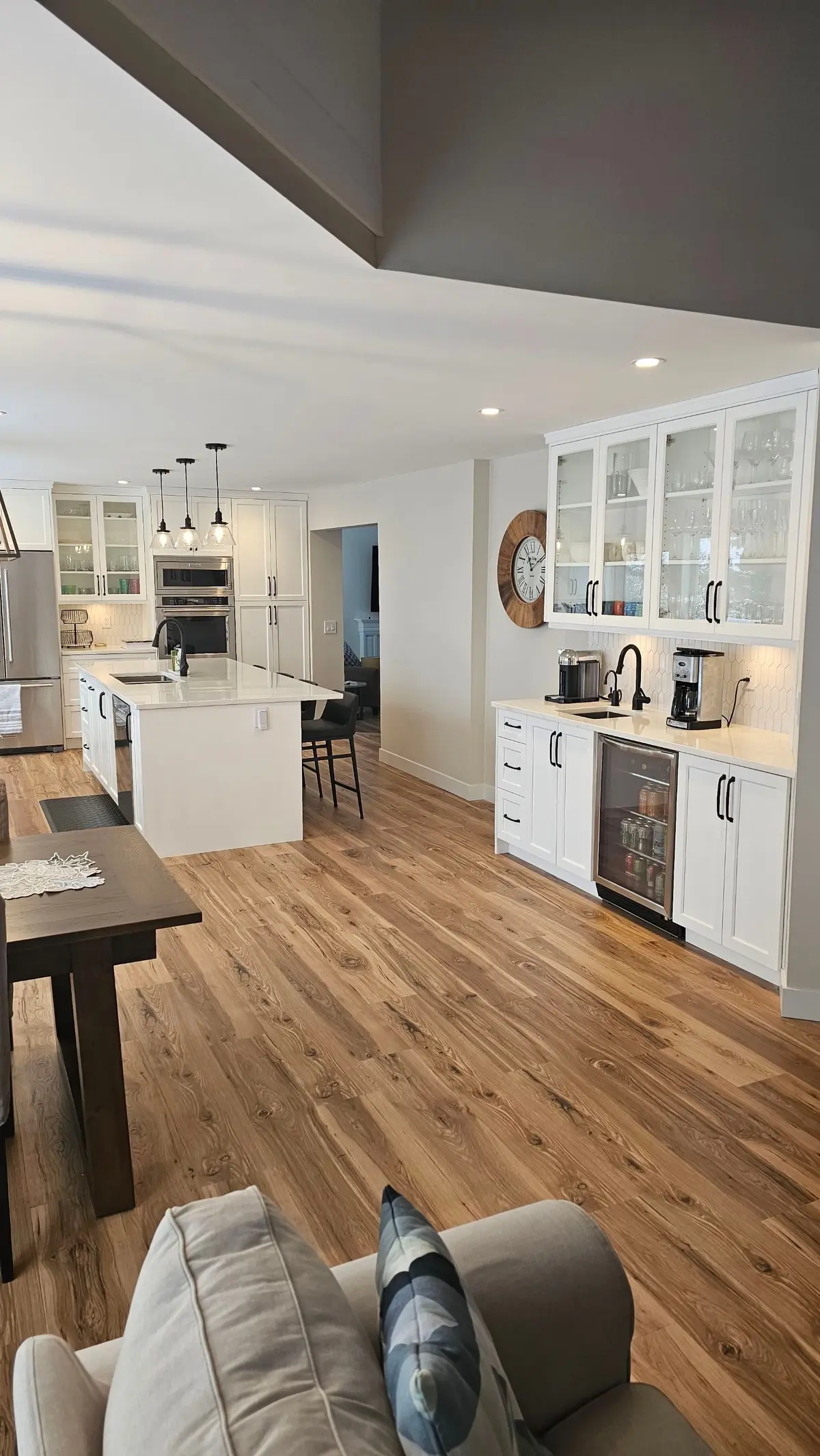 Finished residential kitchen with recessed ceiling lights and pendant lighting over the island.