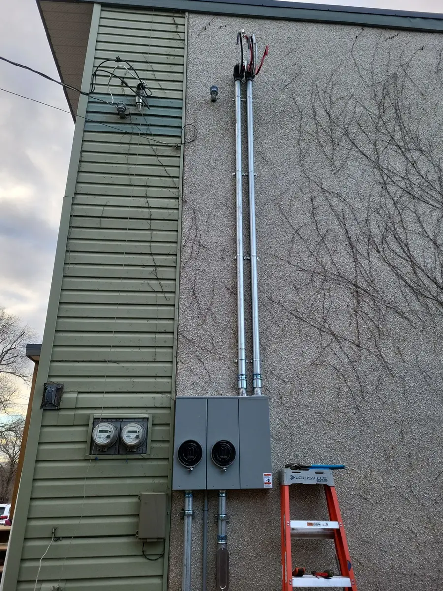 Exterior duplex electrical service equipment and conduit installation.